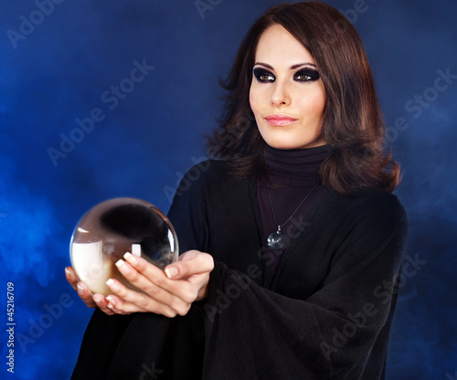 Photo: Young woman with crystal ball. Young woman with crystal ball.