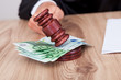 Male Judge Striking The Gavel On Euro Note