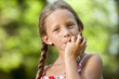 Cute girl licking off chocolate fingers.