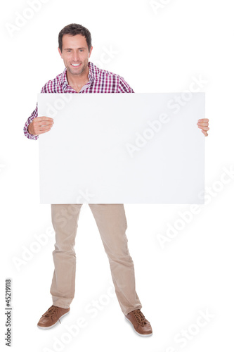 Photo: Portrait Of Young Man Holding Placard Portrait Of Young Man Holding Placard