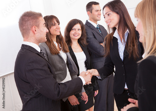 Photo: Businessman And Businesswoman Shaking Hands Businessman And Businesswoman Shaking Hands