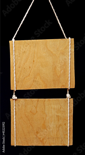 Photo: wooden sign on black background wooden sign on black background