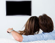 Couple watching tv at home