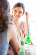 Two young women chatting at outdoor cafe and having fun and beve