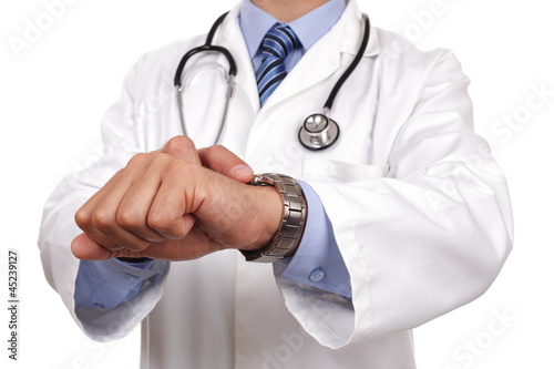 Photo: Doctor checking the time Doctor checking the time