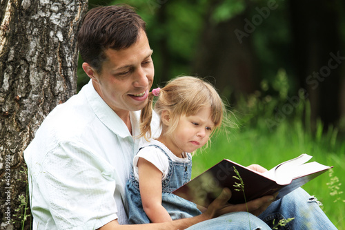 Photo: father and daughter reads the Bible father and daughter reads the Bible