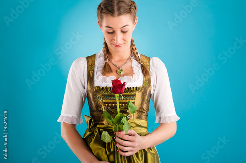 Photo: Young woman in traditional clothes - dirndl or tracht Young woman in traditional clothes - dirndl or tracht