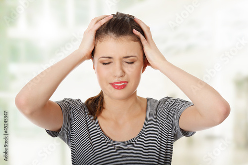 Photo: Teen woman with headache Teen woman with headache