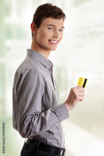 Photo: Young happy businessman holding credit card Young happy businessman holding credit card