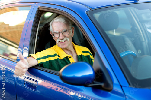Photo: Happy man driving a car Happy man driving a car