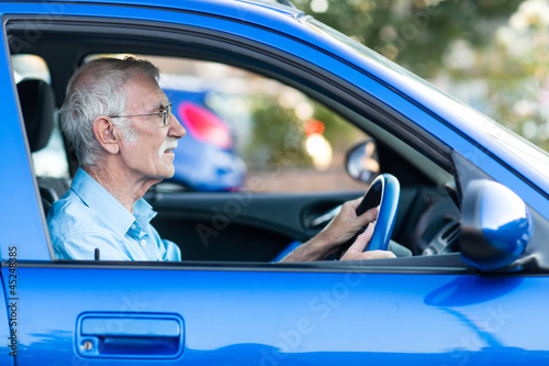 Photo: Elder man driving a car Elder man driving a car