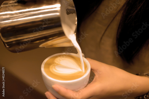 Photo: Hand pouring milk to do Latte art Hand pouring milk to do Latte art