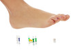 Photo: Female foot above pushpin Female foot above pushpin
