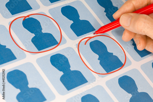 Photo: Hand Selecting Male and Female Candidates with Red Pen Hand Selecting Male and Female Candidates with Red Pen
