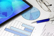 Tablet Computer with Blue Pen Spectacles Figures and Graphs