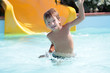 young happy child boy having fun in aquapark