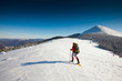 Hiker in winter mountains snowshoeing