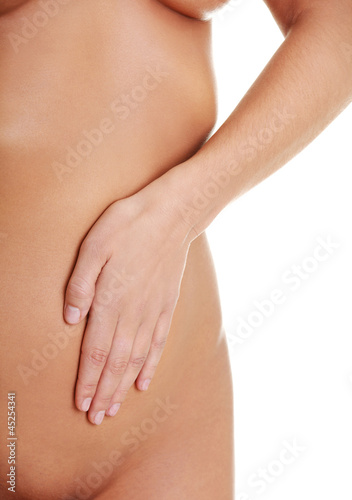 Photo: Fit young woman belly with hand on it Fit young woman belly with hand on it