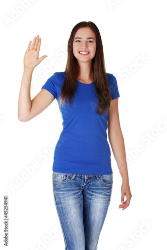 Photo: Happy teenage girl waving a greeting Happy teenage girl waving a greeting