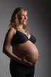 happy pregnant woman holding her belly