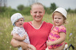 The young woman with two children on hands