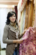woman  chooses draperies