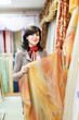 woman  chooses draperies