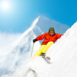 Freeride in fresh powder snow - man skiing downhill