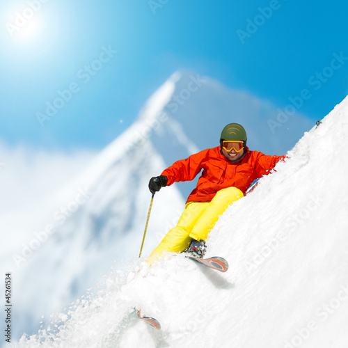 Photo: Freeride in fresh powder snow - man skiing downhill Freeride in fresh powder snow - man skiing downhill