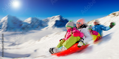 Photo: Winter, snow, family sledding at winter time Winter, snow, family sledding at winter time