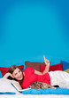 bedtime 20/girl in bed with cat pointing to the ceiling