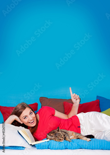 Photo: bedtime 20/girl in bed with cat pointing to the ceiling bedtime 20/girl in bed with cat pointing to the ceiling