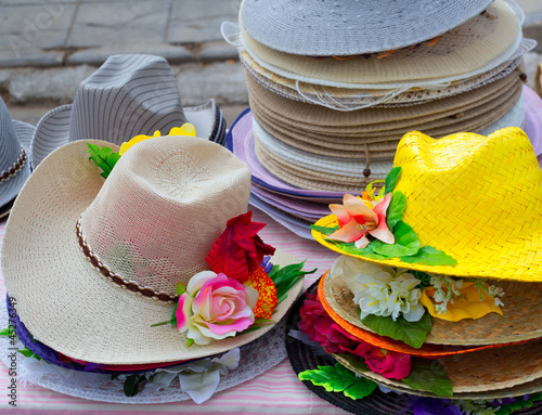 Photo: Colorful straw hats stacked in an outdoor Colorful straw hats stacked in an outdoor