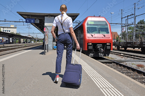 Photo: Girl with a suitcase at the train station Girl with a suitcase at the train station