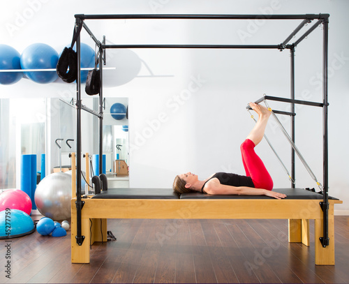 Photo: Pilates aerobic instructor woman in cadillac Pilates aerobic instructor woman in cadillac