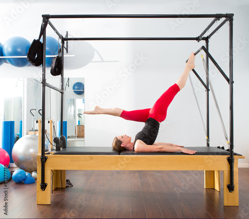 Photo: Pilates aerobic instructor woman in cadillac Pilates aerobic instructor woman in cadillac