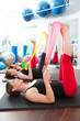 Aerobics pilates women with rubber bands in a row