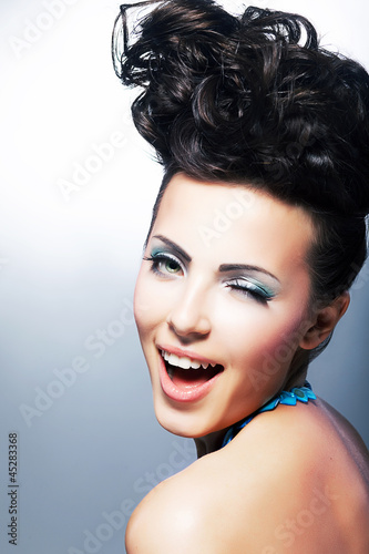 Photo: Portrait of beautiful young laughing shopper woman Portrait of beautiful young laughing shopper woman