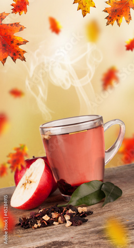 Photo: Autumn cup of tea with concept of falling leaves Autumn cup of tea with concept of falling leaves