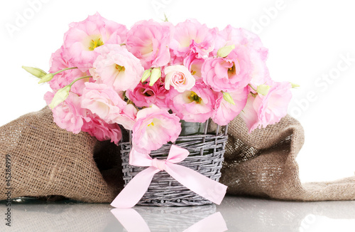 Photo: bouquet of eustoma flowers in wicker vase, isolated on white bouquet of eustoma flowers in wicker vase, isolated on white