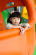 Child plays slide at playground
