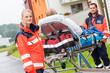 Patient on stretcher with paramedics emergency aid
