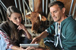 Farmer and veterinarian checking on cows