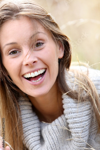 Photo: Beautiful woman standing in country field Beautiful woman standing in country field