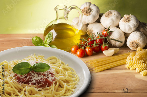 Photo: stil life with olive oil,vegetables on wood table stil life with olive oil,vegetables on wood table