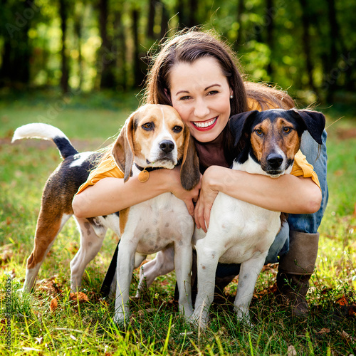 Photo: beautiful woman and his dogs posing outside beautiful woman and his dogs posing outside