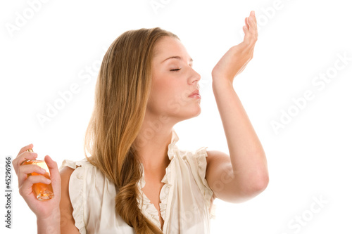 Photo: Woman smelling perfume on her wrist Woman smelling perfume on her wrist
