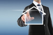 Man with Touchscreen and House