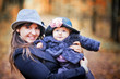 Photo: Little girl and her mother portrait in autumn park Little girl and her mother portrait in autumn park