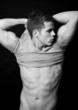 Man with a muscular body on black background